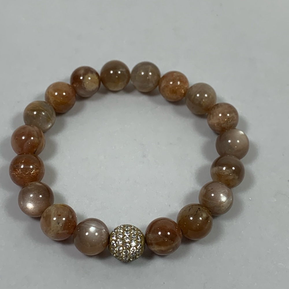 Braclet,  natural beads in a tan mixture with one rhinestone bead